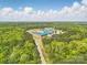 Expansive aerial view showcasing a modern school building nestled within a lush green landscape under a partly cloudy sky at 134 Berkeley Ave, Mooresville, NC 28117