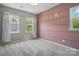 Cozy bedroom with a pink accent wall, plush gray carpet, and ample natural light from the windows at 134 Berkeley Ave, Mooresville, NC 28117