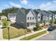 Two-story gray townhome with a landscaped front yard, sidewalk, and well-maintained lawn on a sunny day at 134 Berkeley Ave, Mooresville, NC 28117
