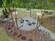 Aerial view of a community fire pit area, featuring seating, landscaping, and overhead lighting at 134 Berkeley Ave, Mooresville, NC 28117