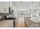 Modern kitchen featuring stainless steel appliances, a kitchen island, and hardwood floors at 134 Berkeley Ave, Mooresville, NC 28117
