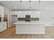 Open kitchen with large island, stainless steel appliances, pendant lighting and modern finishes at 134 Berkeley Ave, Mooresville, NC 28117
