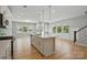 A bright kitchen with a kitchen island, hardwood floors, recessed lighting, and stainless steel appliances at 134 Berkeley Ave, Mooresville, NC 28117