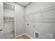 Bright laundry room with wire shelving, light wood flooring, and washer and dryer hookups at 134 Berkeley Ave, Mooresville, NC 28117