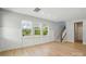 Open-concept living space with wood floors, wainscoting, large windows, and a carpeted staircase at 134 Berkeley Ave, Mooresville, NC 28117