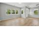 Bright living room featuring large windows, hardwood floors, and neutral walls at 134 Berkeley Ave, Mooresville, NC 28117