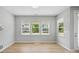 Bright, neutral living space features wood flooring and large windows offering ample natural light at 134 Berkeley Ave, Mooresville, NC 28117