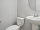 Charming powder room features pedestal sink and neutral tones at 134 Berkeley Ave, Mooresville, NC 28117