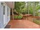 View of the back deck that gives way to wooden stairs leading up a lush and green hillside at 139 Sanford Ln, Badin Lake, NC 28127
