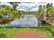 Tranquil lake view with boat docks from the grassy lawn with wooden platform and cozy outdoor seating at 139 Sanford Ln, Badin Lake, NC 28127