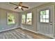 Bedroom showcasing wood-look floors and a bright window, ceiling fan and neutral paint at 139 Sanford Ln, Badin Lake, NC 28127