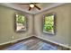 Bedroom featuring wood-look floors, neutral paint and natural light from two windows at 139 Sanford Ln, Badin Lake, NC 28127
