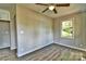 Charming bedroom featuring wood-look floors, a ceiling fan, and a bright window at 139 Sanford Ln, Badin Lake, NC 28127