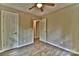 This bedroom features light, neutral-colored walls, wood-look floors, and two white doors at 139 Sanford Ln, Badin Lake, NC 28127