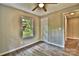 This bedroom features light, neutral-colored walls, wood-look floors, and a window with a view of a garden at 139 Sanford Ln, Badin Lake, NC 28127