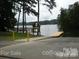 Well-maintained boat ramp leading into a serene lake surrounded by lush greenery at 139 Sanford Ln, Badin Lake, NC 28127