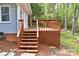 Wooden deck steps featuring lattice-style privacy, leading to tranquil outdoor space at 139 Sanford Ln, Badin Lake, NC 28127