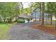 Long gravel driveway leading to charming gray home with lake views and ample parking at 139 Sanford Ln, Badin Lake, NC 28127