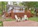Exterior view of home with a deck and outdoor seating that makes a charming, tranquil oasis at 139 Sanford Ln, Badin Lake, NC 28127