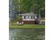 Charming home with lake views and a deck with chairs perfect for relaxing at 139 Sanford Ln, Badin Lake, NC 28127