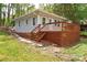 Charming exterior of a gray home with a large deck, perfect for outdoor living at 139 Sanford Ln, Badin Lake, NC 28127