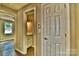 Hallway view leading to a bathroom with modern flooring, neutral colors, and door at 139 Sanford Ln, Badin Lake, NC 28127
