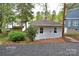 Charming home with a well-kept lawn and gravel driveway next to the lake at 139 Sanford Ln, Badin Lake, NC 28127