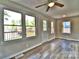 Light filled living room with hardwood floors, ceiling fan and lake views from large windows at 139 Sanford Ln, Badin Lake, NC 28127