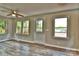 Living room showcasing wood-look floors and windows with lake views, complemented by a ceiling fan at 139 Sanford Ln, Badin Lake, NC 28127