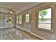 Bright living room with hardwood floors, ceiling fan and stunning views from the large windows at 139 Sanford Ln, Badin Lake, NC 28127