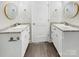 Bathroom with a double sink vanity with a round mirror and modern fixtures at 1399 Foxbrook Cir, Lancaster, SC 29720