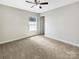 Bedroom with neutral walls, plush carpet, window, and a ceiling fan at 1399 Foxbrook Cir, Lancaster, SC 29720