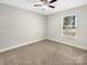 Cozy carpeted bedroom featuring neutral paint and a bright window view at 1399 Foxbrook Cir, Lancaster, SC 29720