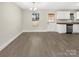 Bright dining area with modern light fixture and view to the kitchen with stainless steel appliances at 1399 Foxbrook Cir, Lancaster, SC 29720