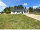 Charming single story home featuring a well-manicured lawn and a concrete driveway at 1399 Foxbrook Cir, Lancaster, SC 29720