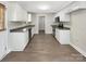 Efficient kitchen featuring white cabinets, stainless steel appliances, and wood-look flooring at 1399 Foxbrook Cir, Lancaster, SC 29720