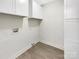 Laundry room featuring a washer and dryer hookups, storage cabinet and tile floor at 1399 Foxbrook Cir, Lancaster, SC 29720