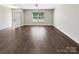 Open floor plan showcasing the spacious living room with wood-look flooring at 1399 Foxbrook Cir, Lancaster, SC 29720