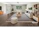 Bright, inviting living room with a striped rug, white couch and modern decor at 1399 Foxbrook Cir, Lancaster, SC 29720