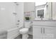 Bright bathroom featuring tub with shower, quartz counters, and modern fixtures at 1412 W 4Th St, Charlotte, NC 28208
