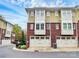 Townhomes with brick and siding, garage parking, and manicured landscaping, creating curb appeal at 1412 W 4Th St, Charlotte, NC 28208