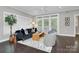 Bright living room features a modern sofa, ceiling fan and large sliding glass doors at 1412 W 4Th St, Charlotte, NC 28208