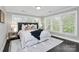Bright main bedroom with large windows, plush bedding, and stylish decor creating a relaxing retreat at 1412 W 4Th St, Charlotte, NC 28208