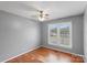Bedroom with ceiling fan, hardwood floors, and a bright window at 1504 Andicot Ln, Shelby, NC 28152