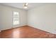 Well-lit bedroom with light walls, wood-look floors, and a ceiling fan at 1504 Andicot Ln, Shelby, NC 28152