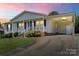 Charming single-story home with a inviting front porch, carport, and a well-maintained lawn at 1504 Andicot Ln, Shelby, NC 28152