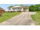Attractive ranch-style home with a covered carport, landscaped front yard, and an extended driveway at 1504 Andicot Ln, Shelby, NC 28152