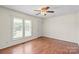 Bright living room featuring hardwood floors, a ceiling fan, and a large window at 1504 Andicot Ln, Shelby, NC 28152