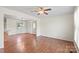Open living area with hardwood floors, white walls, and access to the kitchen at 1504 Andicot Ln, Shelby, NC 28152