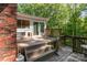 Wooden back deck with stairs leading to the yard, connected to the house with sliding glass doors at 1565 Oakridge Dr, Salisbury, NC 28146